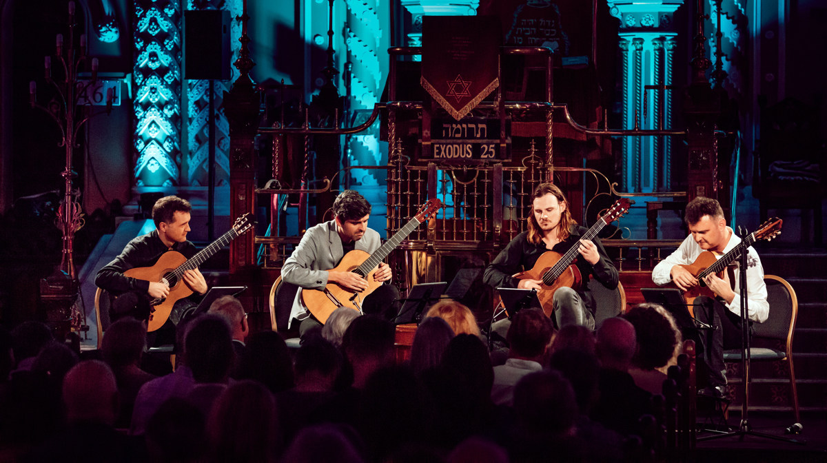 Australian Guitar Quartet on stage playing guitar